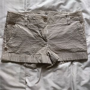 Tan/white seersucker shorts with button details and cuff. Size 10